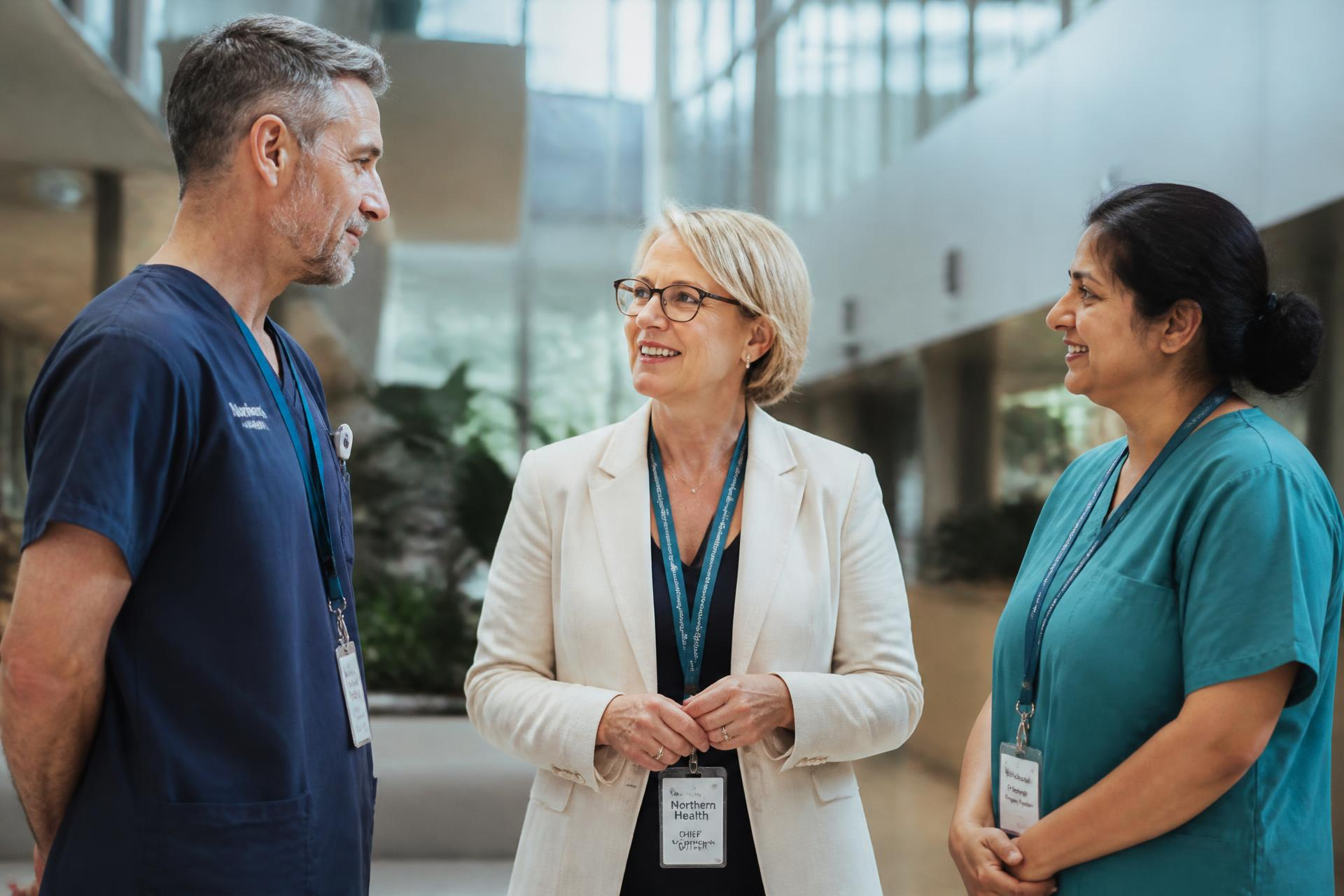 Healthcare leaders in conversation in a hospital